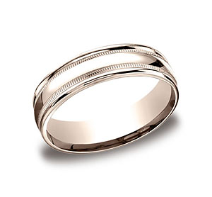 This 6mm comfort-fit carved design band features a high polished finish with milgrain and a round edge.